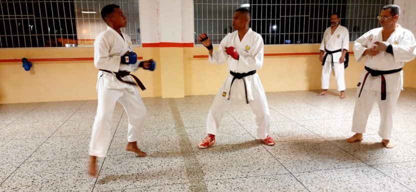 Karateka adolescente hace sparring con uno de sus instructores 