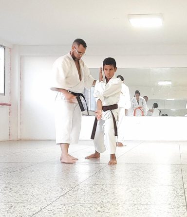 Sensei explica movimiento a alumno durate clase de Karate